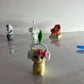 Small figurine with headphones and a bow on a reflective surface